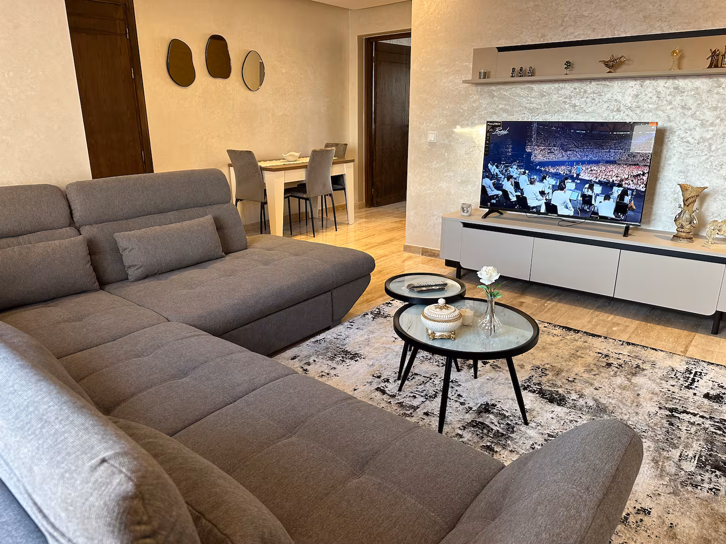 Living room with a grey sectional sofa and dining table