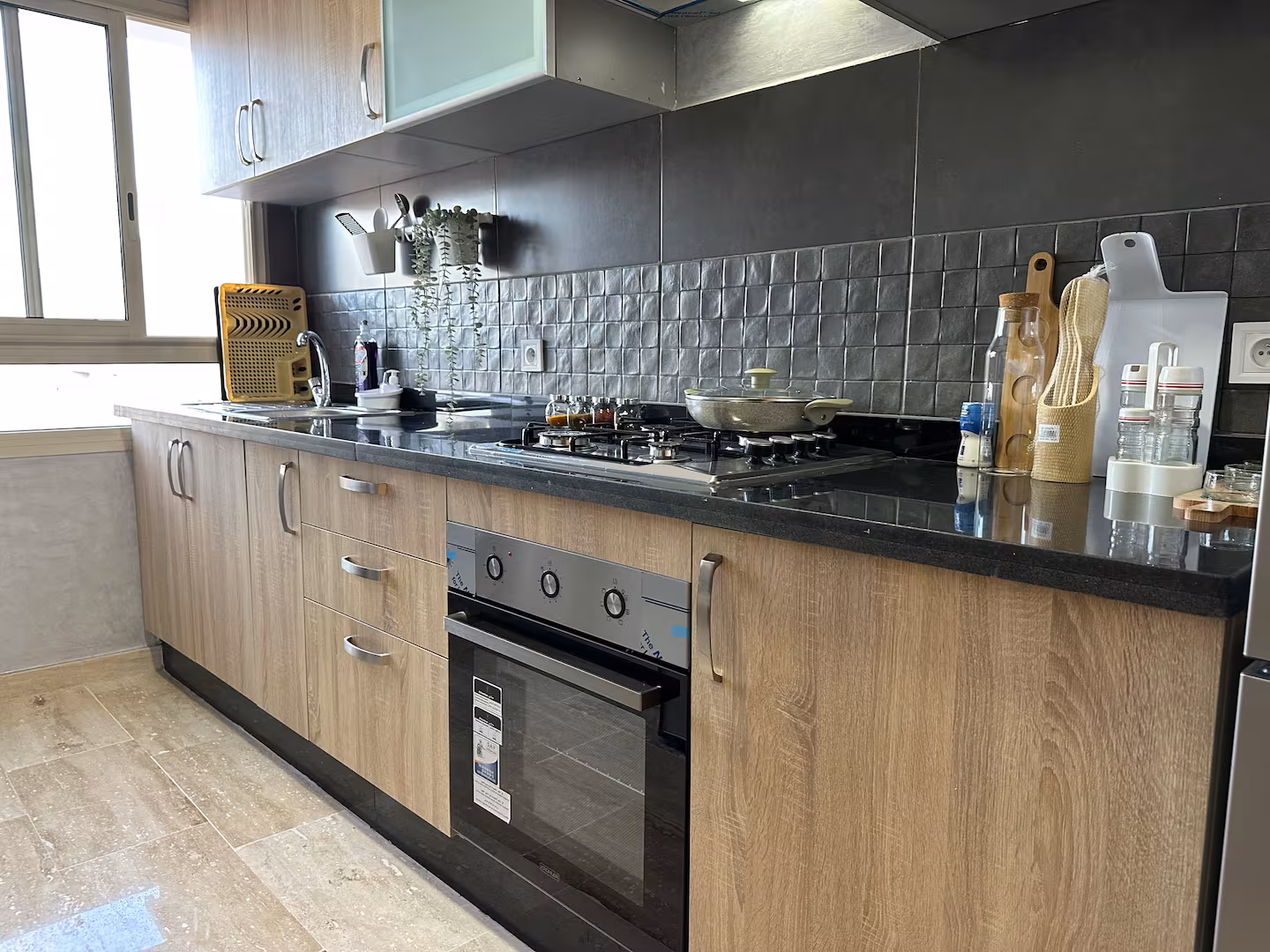 Kitchen counter with cabinets and gas cooktop