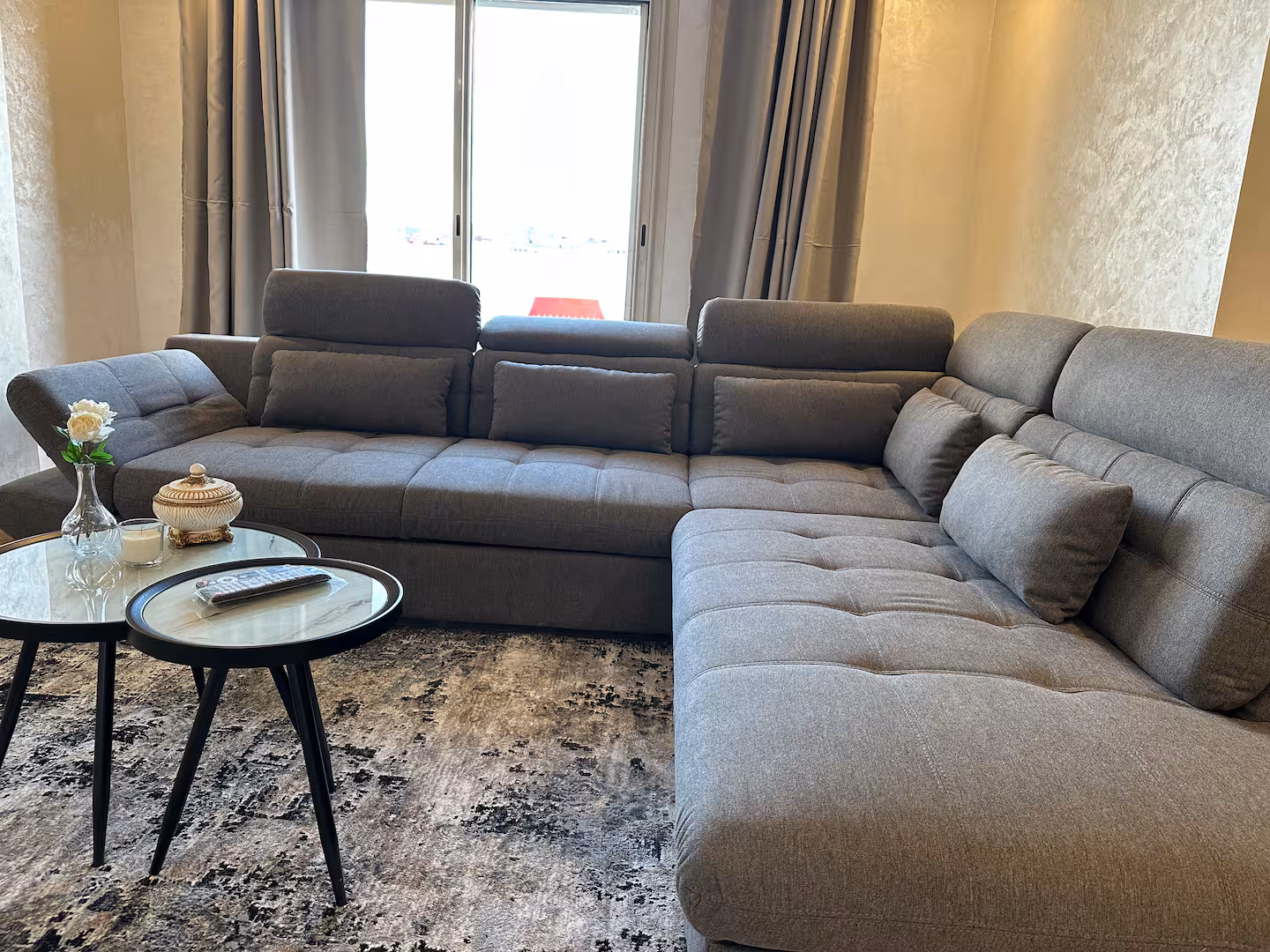 Living room with grey sectional sofa and natural light